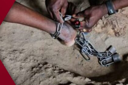 Gaunt, malnourished man sitting on bare floor after being rescued from 17-year illegal captivity and chaining by his father in Nigeria